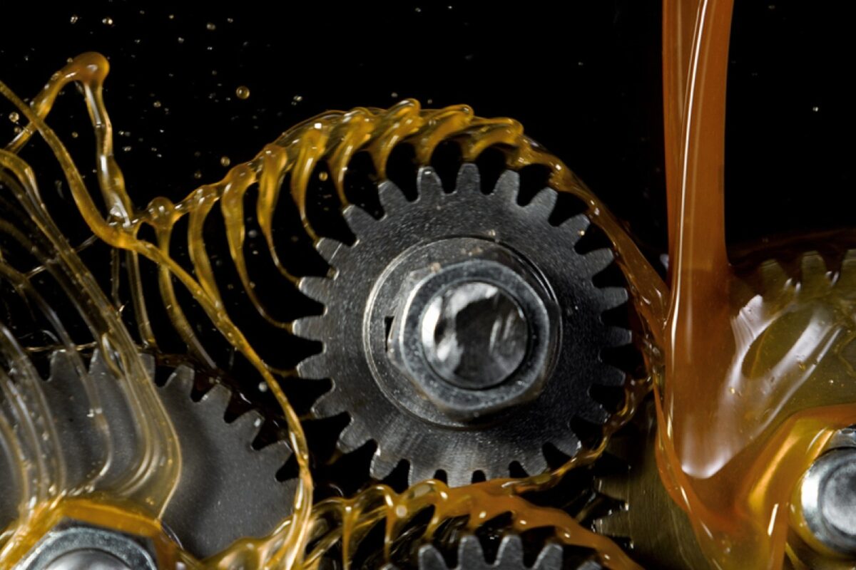 Industrial gear oil flowing over precision machine gears