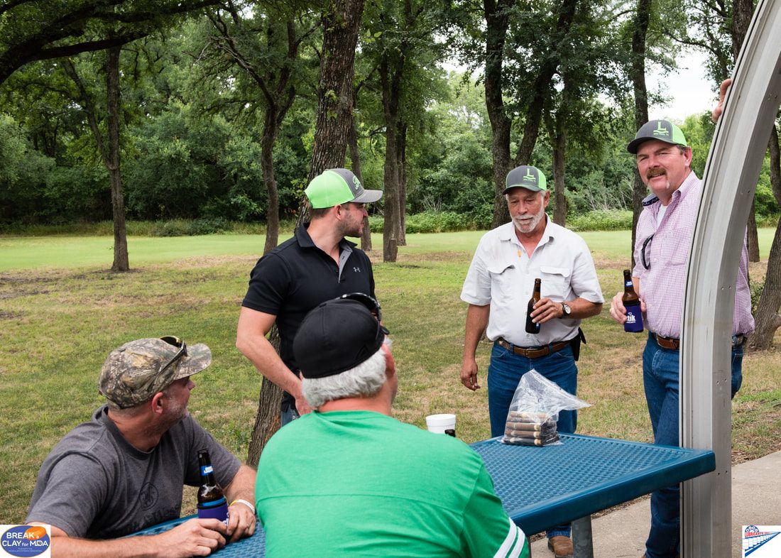 Participants at the clay shooting stations, Break a Clay for MDA 2017